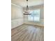 Formal dining room with elegant wainscoting, chandelier and large window at 1695 Crumbley Rd, Mcdonough, GA 30252