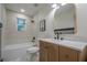 Bathroom boasts a marble counter, modern sink and fixtures, and tiled shower at 2825 Shea Sw Way, Marietta, GA 30060