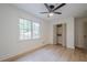 Bright bedroom with a ceiling fan, closet, wood floors, and large window at 2825 Shea Sw Way, Marietta, GA 30060