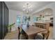 Dining room boasts modern chandelier, access to kitchen and backyard through glass doors at 2825 Shea Sw Way, Marietta, GA 30060