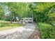 Landscaped front yard and long driveway leading up to this beautiful home nestled among mature trees at 2825 Shea Sw Way, Marietta, GA 30060