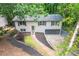Charming home with landscaped yard, grey roof, black shutters and attached garage at 2825 Shea Sw Way, Marietta, GA 30060