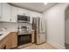Kitchen with white upper cabinets and wooden lower cabinets and stainless steel appliances at 2825 Shea Sw Way, Marietta, GA 30060
