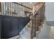 Modern staircase featuring wood treads, black metal railings, and contrasting black wainscoting at 2825 Shea Sw Way, Marietta, GA 30060
