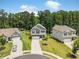 Scenic aerial shot of homes with verdant lawns and long driveways in a wooded community at 340 Louise Ln, Canton, GA 30114