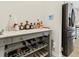 Close up of bar area featuring custom shelves with liquor and beverage storage and stainless steel refrigerator at 340 Louise Ln, Canton, GA 30114