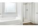 This bright bathroom features a shower, a soaking tub, and subway tile accents at 340 Louise Ln, Canton, GA 30114