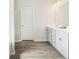 A well lit bathroom with a dual vanity sink, modern cabinetry and wood look floors at 340 Louise Ln, Canton, GA 30114