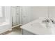 Bathroom featuring a dual vanity, a glass shower, and a tub at 340 Louise Ln, Canton, GA 30114