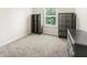 Well lit bedroom with grey carpet, a window and two dark shelving units at 340 Louise Ln, Canton, GA 30114