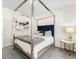 Modern bedroom features a stylish four-poster bed with a blue velvet headboard at 340 Louise Ln, Canton, GA 30114