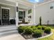 Inviting front porch featuring seating, manicured shrubs, landscaping stones, and decorative 'Welcome' sign at 340 Louise Ln, Canton, GA 30114