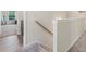 Upstairs hallway with carpeting, wood railing, and natural light at 340 Louise Ln, Canton, GA 30114