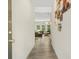 Hallway leading to a spacious living room with wood floors and natural light at 340 Louise Ln, Canton, GA 30114