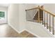 Entryway hallway with wood floors and staircase with wood and metal railing at 340 Louise Ln, Canton, GA 30114