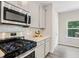 Kitchen boasts stainless steel appliances, marble backsplash and updated cabinets at 340 Louise Ln, Canton, GA 30114