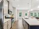 Modern kitchen with stainless steel appliances, center island, and view to the back deck at 340 Louise Ln, Canton, GA 30114