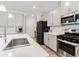 Kitchen featuring stainless steel appliances, gas range, sleek white countertops, and ample cabinet space at 340 Louise Ln, Canton, GA 30114