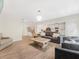 Open living area with wood flooring, modern lighting, and view to kitchen and staircase at 340 Louise Ln, Canton, GA 30114