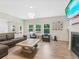 Bright living room features modern chandelier, cozy seating, and a fireplace with mounted TV at 340 Louise Ln, Canton, GA 30114