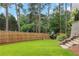 Fenced backyard with a playset and lush green lawn, offering a safe and fun space for children at 4250 Summit Dr, Marietta, GA 30068