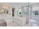 Luxurious bathroom featuring a soaking tub, glass-enclosed shower, and marble accents at 4250 Summit Dr, Marietta, GA 30068