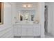 Elegant bathroom vanity with white cabinetry, large mirror, and decorative accents at 4250 Summit Dr, Marietta, GA 30068