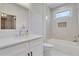 Bright bathroom featuring modern vanity, bathtub, and tiled shower with window at 4250 Summit Dr, Marietta, GA 30068