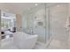 Bathroom showcasing a glass-enclosed shower and modern tub with marble tile at 4250 Summit Dr, Marietta, GA 30068