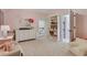 Comfortable bedroom with pink paint, dresser, storage, and easy access to bathroom at 4250 Summit Dr, Marietta, GA 30068