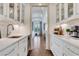 Well-appointed butler's pantry with white cabinetry, a beverage fridge, and ample counter space for entertaining at 4250 Summit Dr, Marietta, GA 30068
