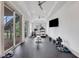 Home exercise room with rubber flooring, ceiling fans, and sliding glass doors leading to the outdoors at 4250 Summit Dr, Marietta, GA 30068