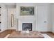 Close up of the fireplace with painting above mantel and padded ottoman in front at 4250 Summit Dr, Marietta, GA 30068