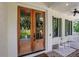 Elegant double front doors adorned with wreaths, complemented by green shutters and rocking chairs on the porch at 4250 Summit Dr, Marietta, GA 30068