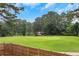 Scenic view overlooking a lush green golf course with mature trees and blue skies, offering a serene setting at 4250 Summit Dr, Marietta, GA 30068
