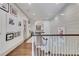 Upper level hallway with wooden floors, stylish artwork, and natural lighting at 4250 Summit Dr, Marietta, GA 30068