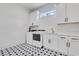 Bright laundry room with white cabinets, patterned floor, and modern appliances at 4250 Summit Dr, Marietta, GA 30068