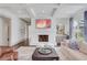 Spacious living room featuring white brick fireplace, coffered ceilings, and natural light at 4250 Summit Dr, Marietta, GA 30068