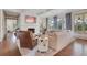 Bright, open living room boasting a white brick fireplace, large windows, and hardwood floors at 4250 Summit Dr, Marietta, GA 30068