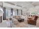 Expansive living room with fireplace, coffered ceilings, large windows, and open to the kitchen at 4250 Summit Dr, Marietta, GA 30068