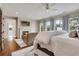 Bright main bedroom with hardwood floors, fireplace, sitting area, and large windows at 4250 Summit Dr, Marietta, GA 30068