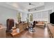 Bright home office featuring tray ceilings, hardwood flooring, a wooden desk, and comfortable seating for work at 4250 Summit Dr, Marietta, GA 30068