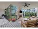 Covered outdoor living space with a fireplace, ceiling fan, and a view of the wooded backyard at 4250 Summit Dr, Marietta, GA 30068
