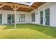 Outdoor patio area with artificial grass, white siding, ceiling beams, and sliding glass doors at 4250 Summit Dr, Marietta, GA 30068