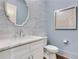 Stylish powder room with blue wallpaper, marble vanity, and decorative mirror at 4250 Summit Dr, Marietta, GA 30068