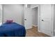 Bedroom featuring gray walls, wood look flooring, and a bed with a blue cover and purple decorative pillow at 1174 Princess Sw Ave, Atlanta, GA 30310