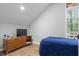 Bedroom with light gray walls, wood look flooring, a flat screen TV, and a window with blinds at 1174 Princess Sw Ave, Atlanta, GA 30310