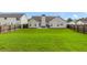 A large backyard featuring a neutral-colored home, a patio, and a privacy fence at 3589 Garden Manor Dr, Loganville, GA 30052