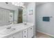 Bathroom featuring double sinks and bathtub with a shower at 3589 Garden Manor Dr, Loganville, GA 30052