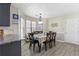 Cozy dining room with a bright window, hardwood floors, and an adjacent modern kitchen at 3589 Garden Manor Dr, Loganville, GA 30052